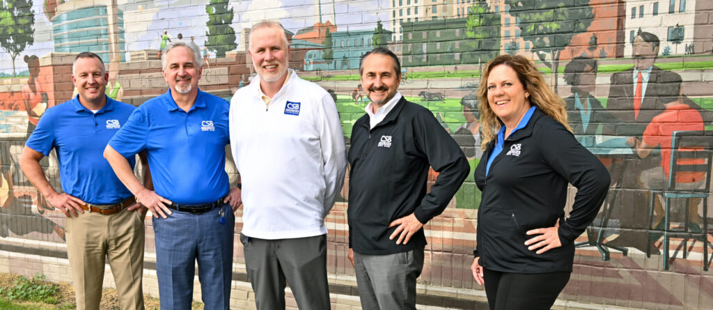 Jackson Team in front of painted mural outside Jackson Branch