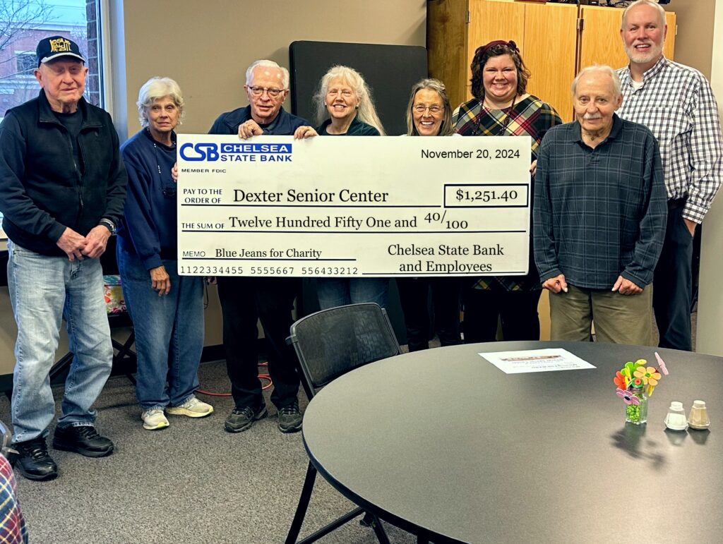 Members of the Dexter Senior Center stand with Emily Schaible and Bill Bacon of Chelsea State Bank.